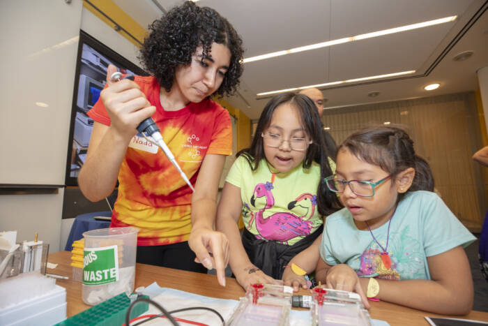 At at a station on tools of the lab, visitors could learn to handle equipment such as pipettes, centrifuges, and gels.