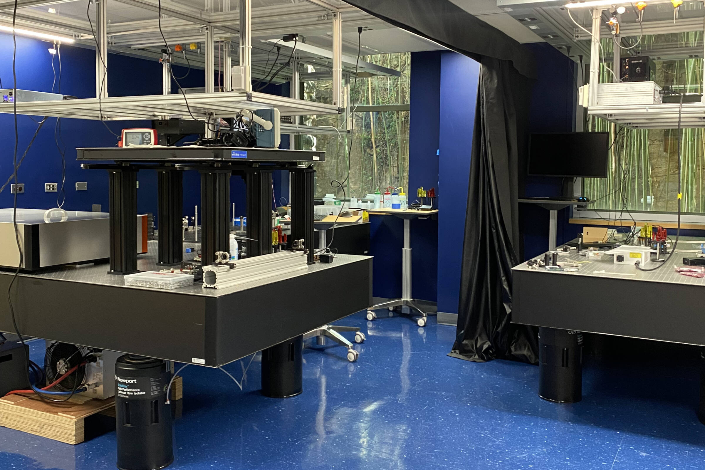 Brain imaging instruments on tables in a room with a blue floor and blue walls