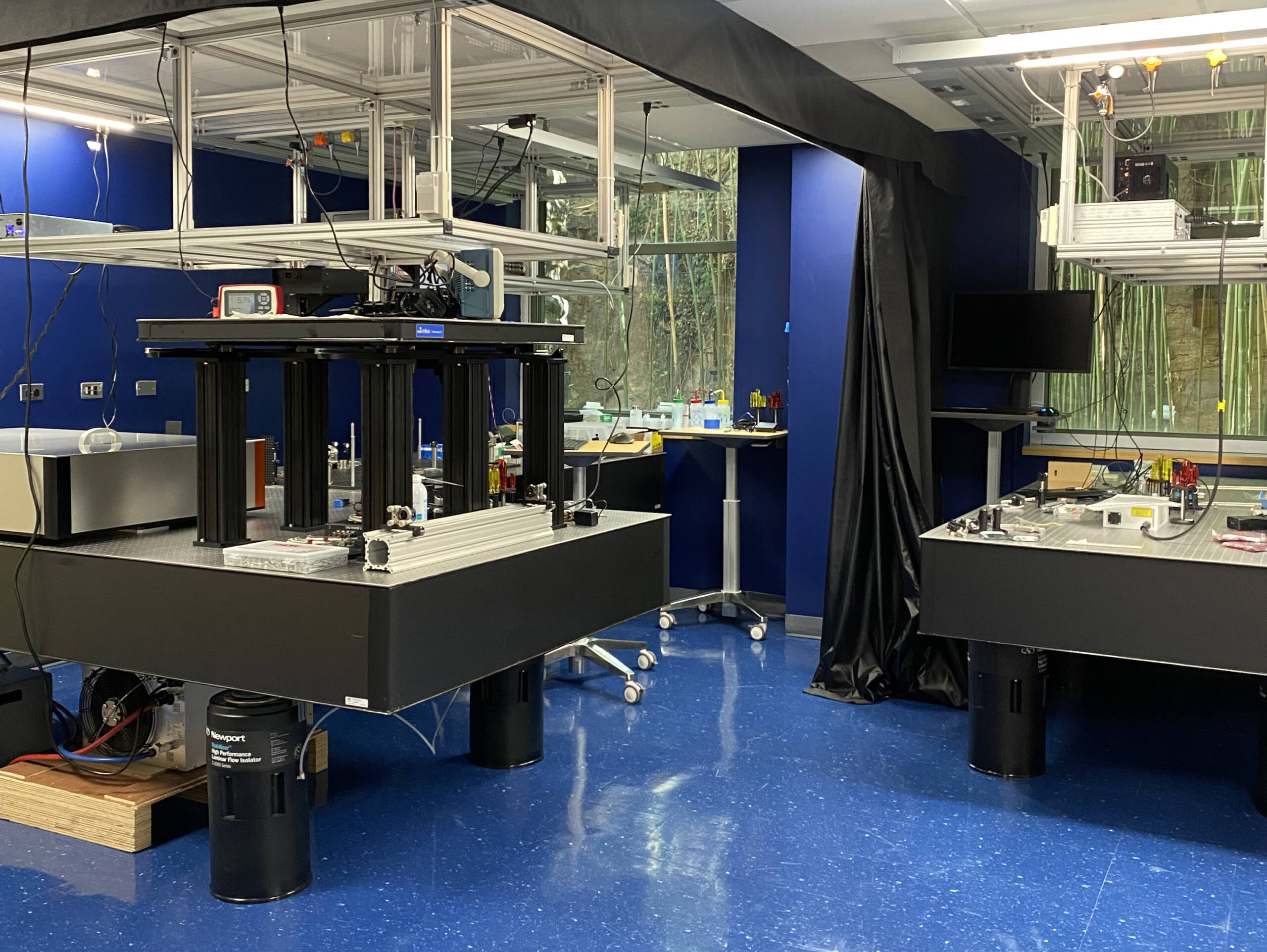 Brain imaging instruments on tables in a room with a blue floor and blue walls