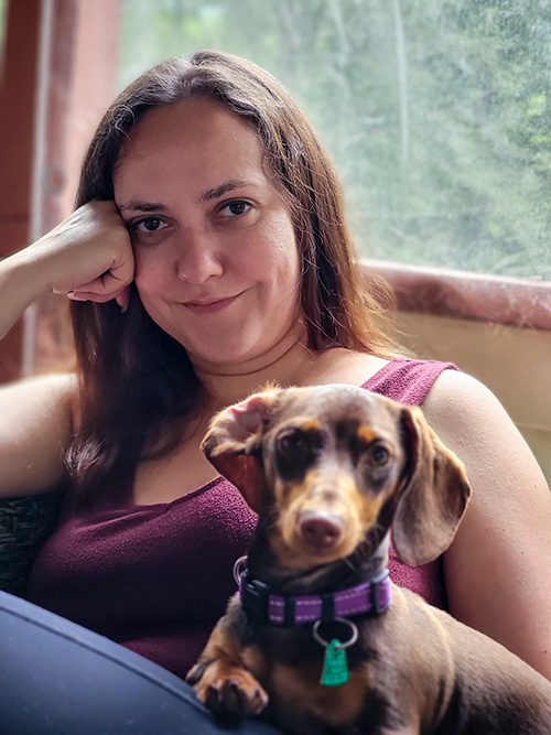 Inna Piscitello sitting on a couch with a dog