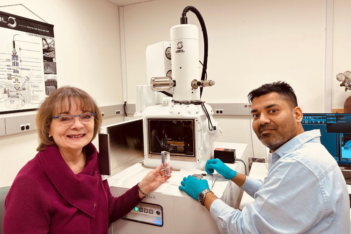 Two scientists at an electron microscope